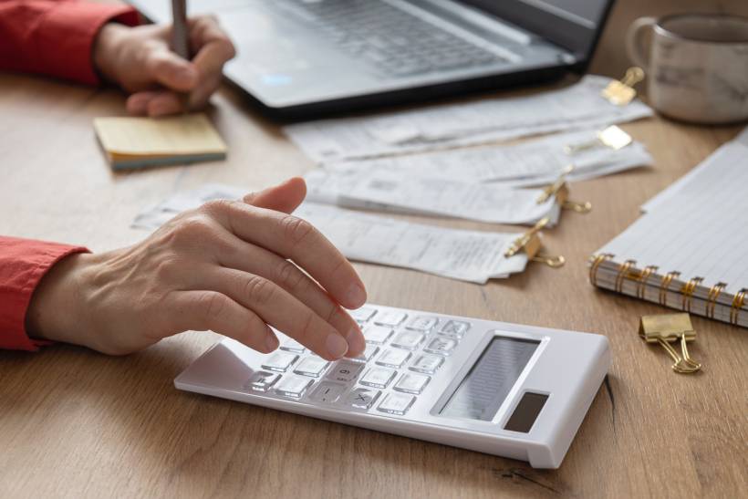 how to make money with photography - Photography service cost calculation in progress with financial documents on a desk