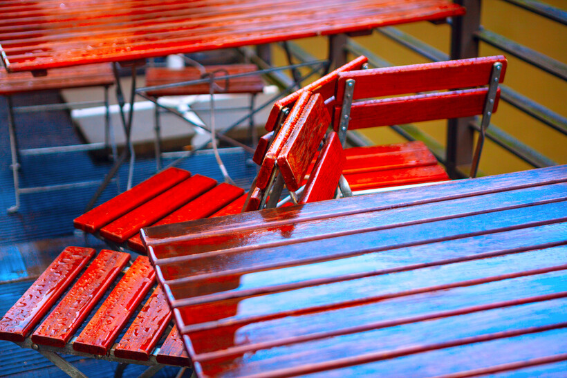 Detailed close-up of water droplets clinging to a durable painted outdoor table surface. - satin vs gloss paint