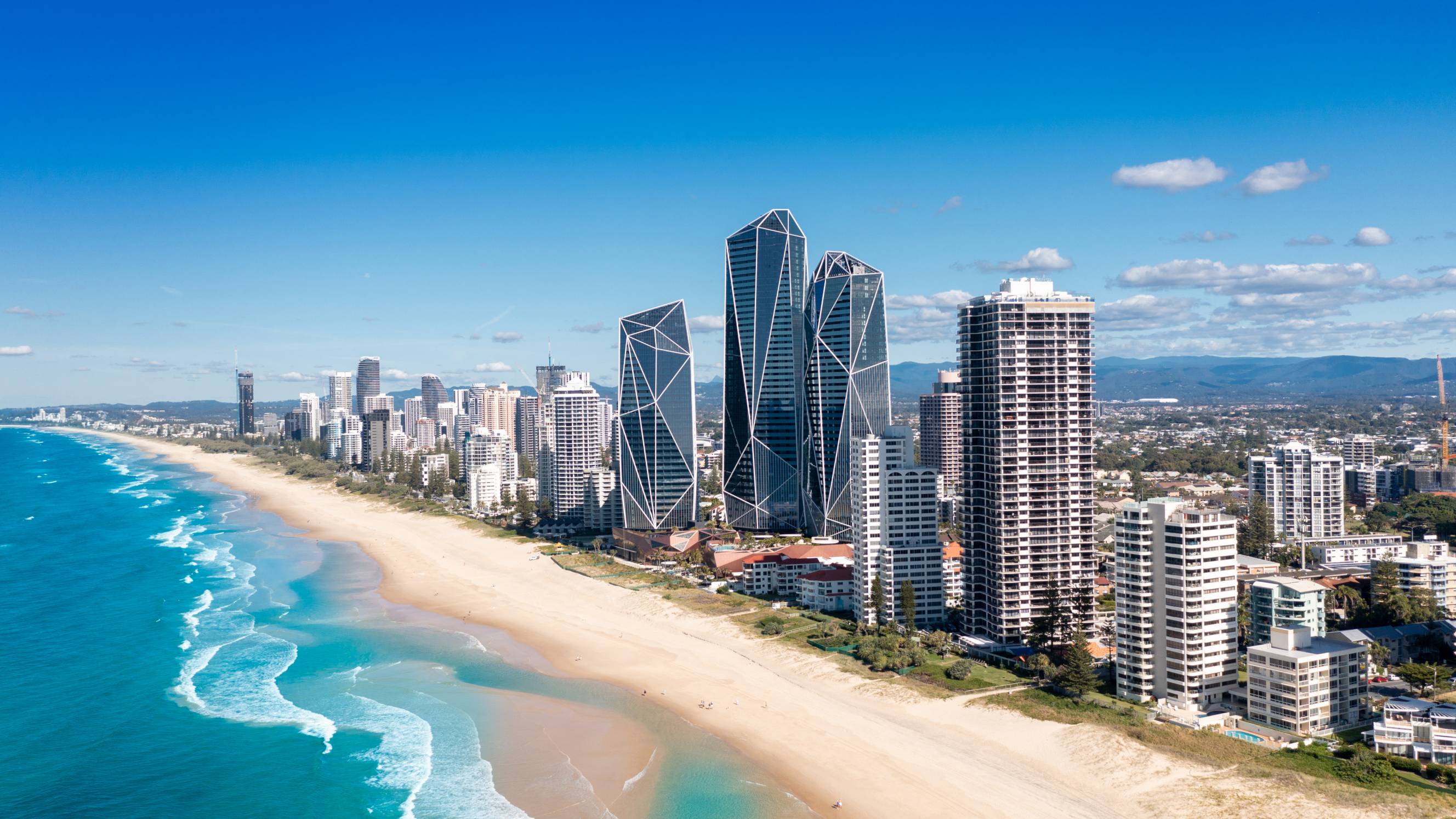 Wide shot of the Gold Coast skyline and coastline featuring the Jewel towers and white sandy beaches stretching into the distance.