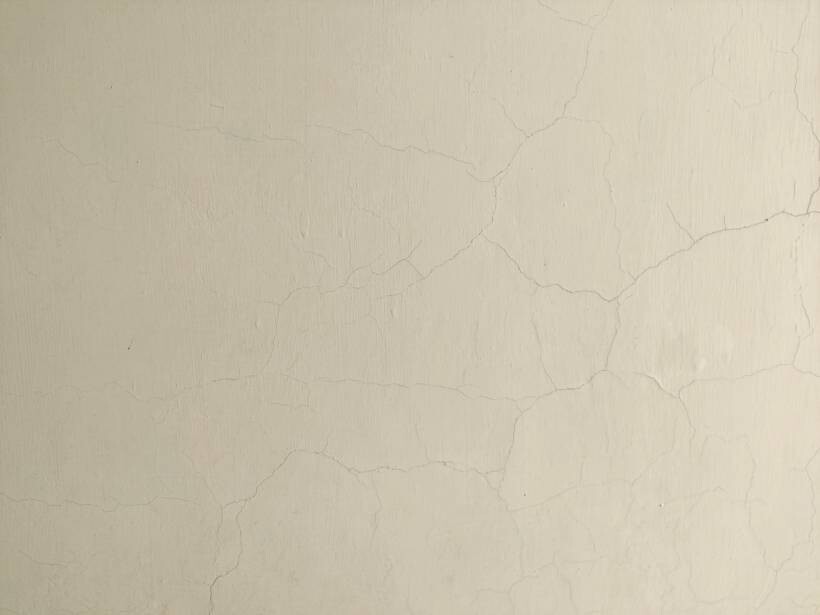 how to limewash walls - Pale textured wall with fine hairline cracks
