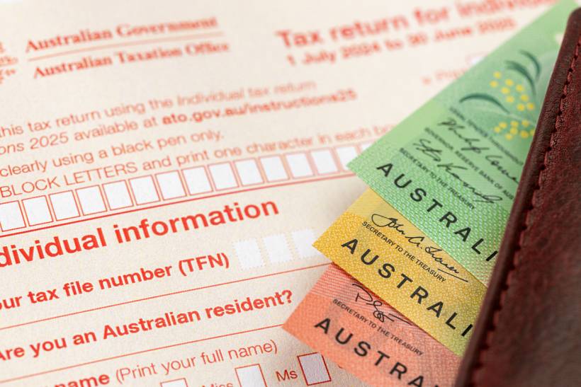 how much does a tax accountant cost - Australian tax return form with cash notes and leather wallet