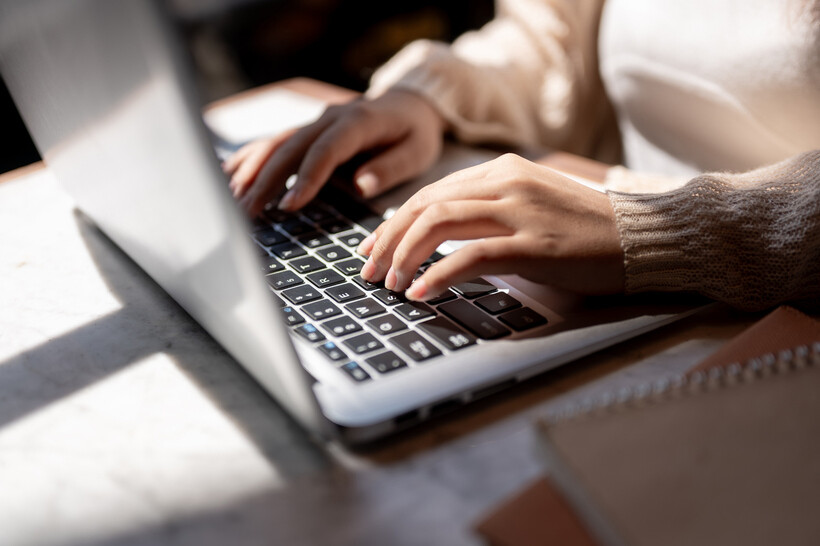Close-up of hands typing on a keyboard during admin work. - retail tasks