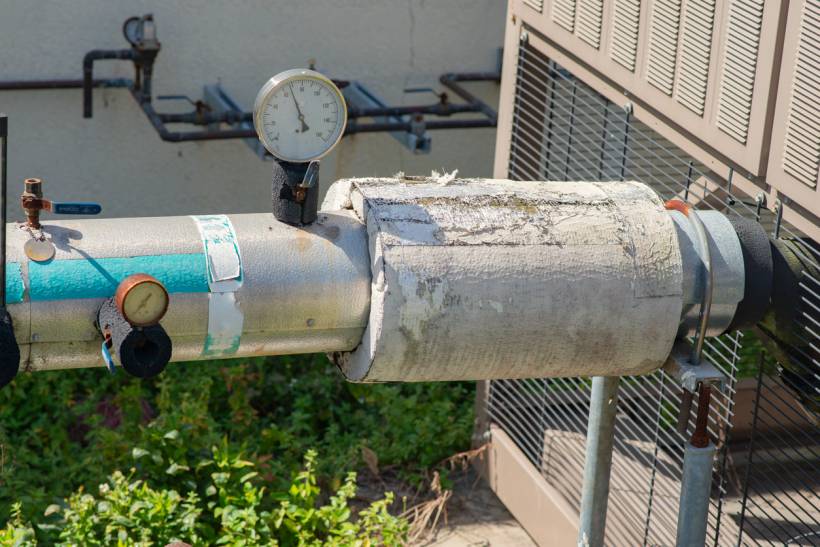 how to identify asbestos - Weathered pipe insulation with frayed white fibrous material