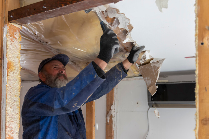 Worker in protective gear preparing a residential space for renovation work. - after builders cleaning
