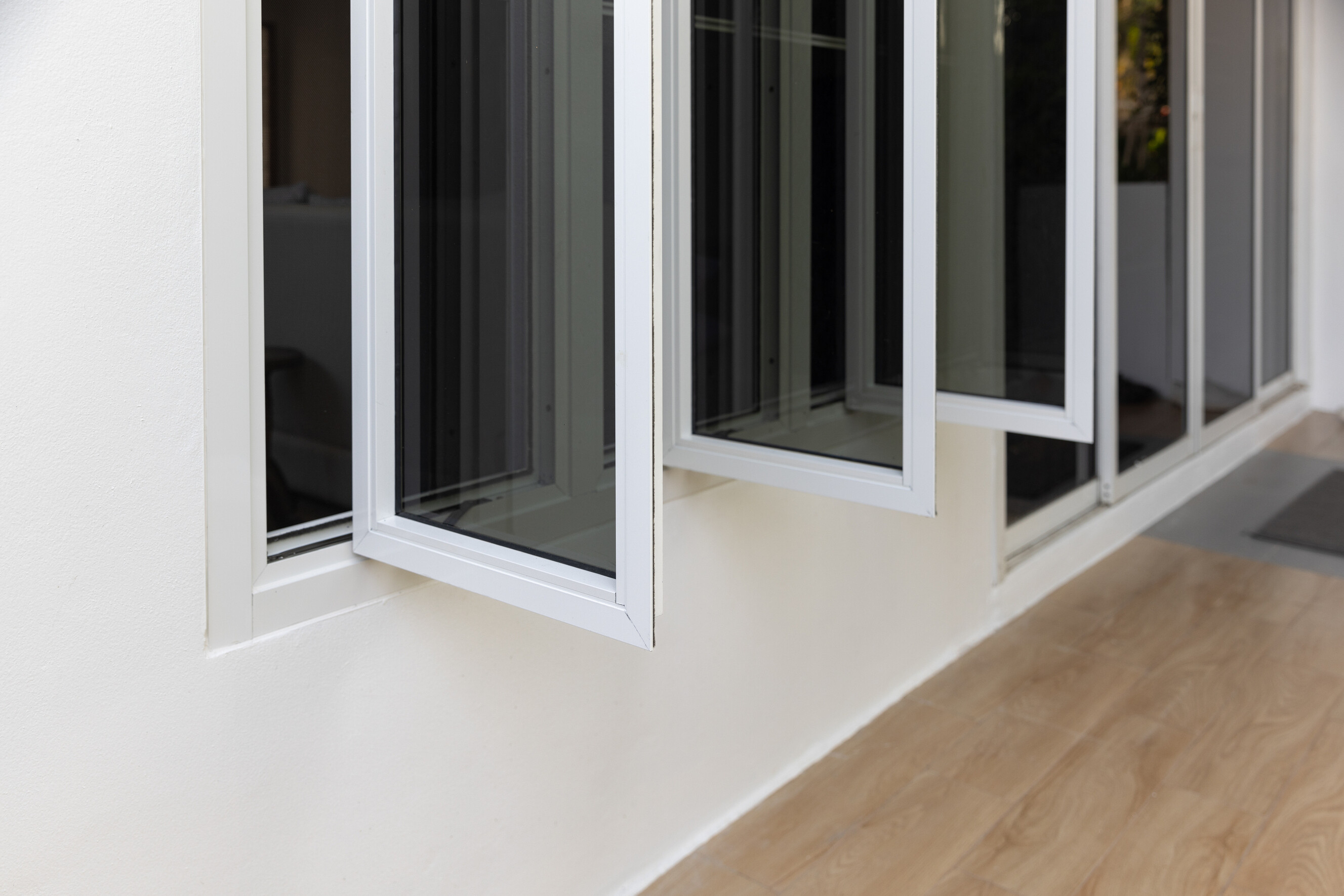 Three-panel casement window showcasing sleek aluminium framing in a home.