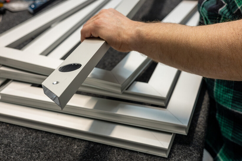Close-up of aluminium window frame profiles stacked ready for assembly. - aluminium windows cost