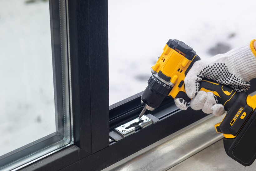 Installer fitting and adjusting components on an aluminium window frame. - aluminium windows cost