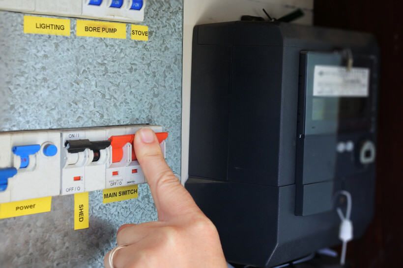Homeowner locating and pressing the main switch on a home electrical panel. - how to use switchboard