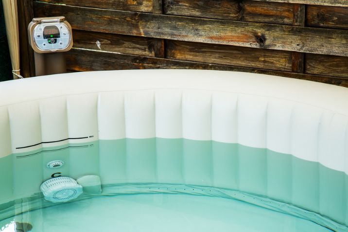 A portable inflatable hot tub with filtration unit