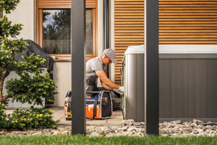 A technician servicing a residential hot tub