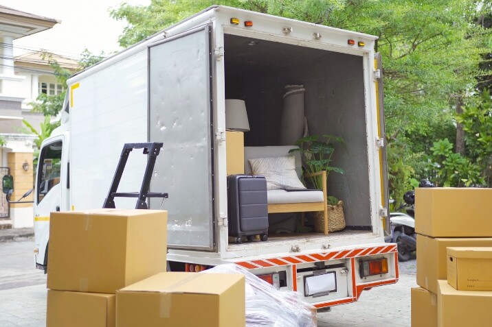 The back of a moving truck carrying goods
