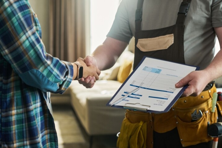 A man welcoming a handyman at home