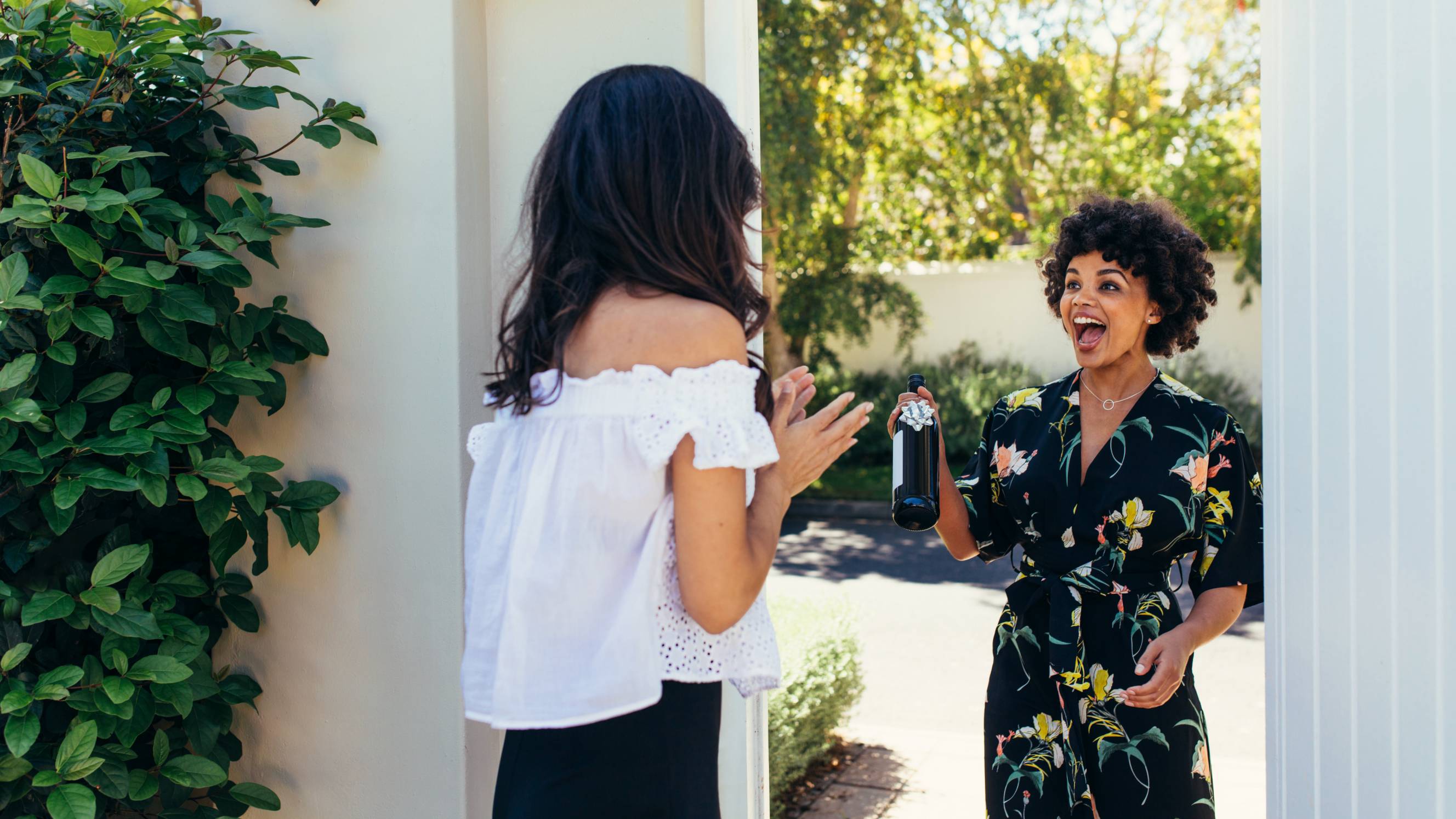 Excited woman with wine for a housewarming party
