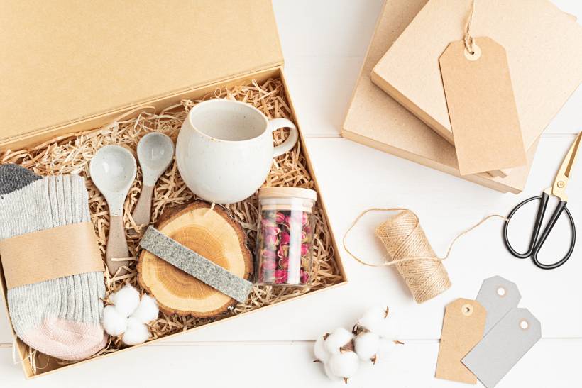 housewarming gift ideas - Curated gift box with ceramic mug, spoons, socks, dried flowers, and wooden coaster