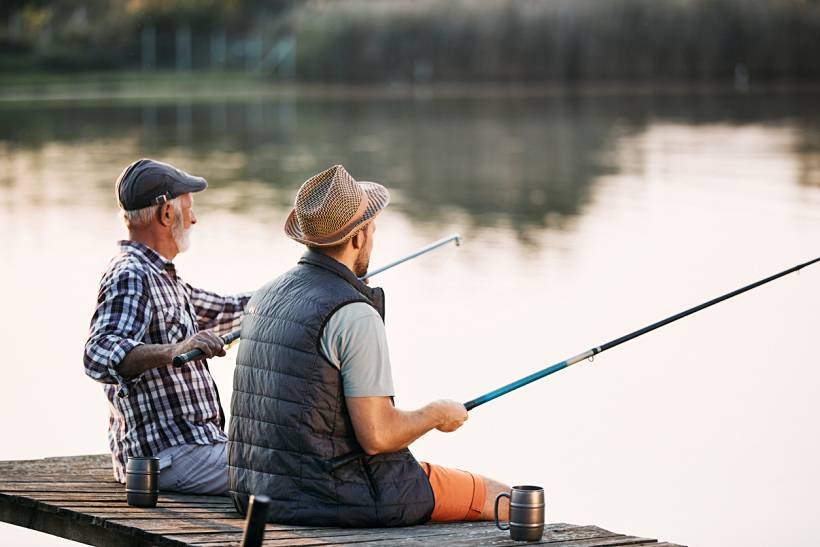 Father's Day gift ideas - Father and son fishing together from a wooden dock