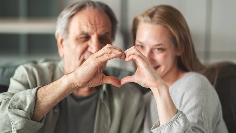 Father's Day gift ideas - Older man and woman forming a heart shape with their hands