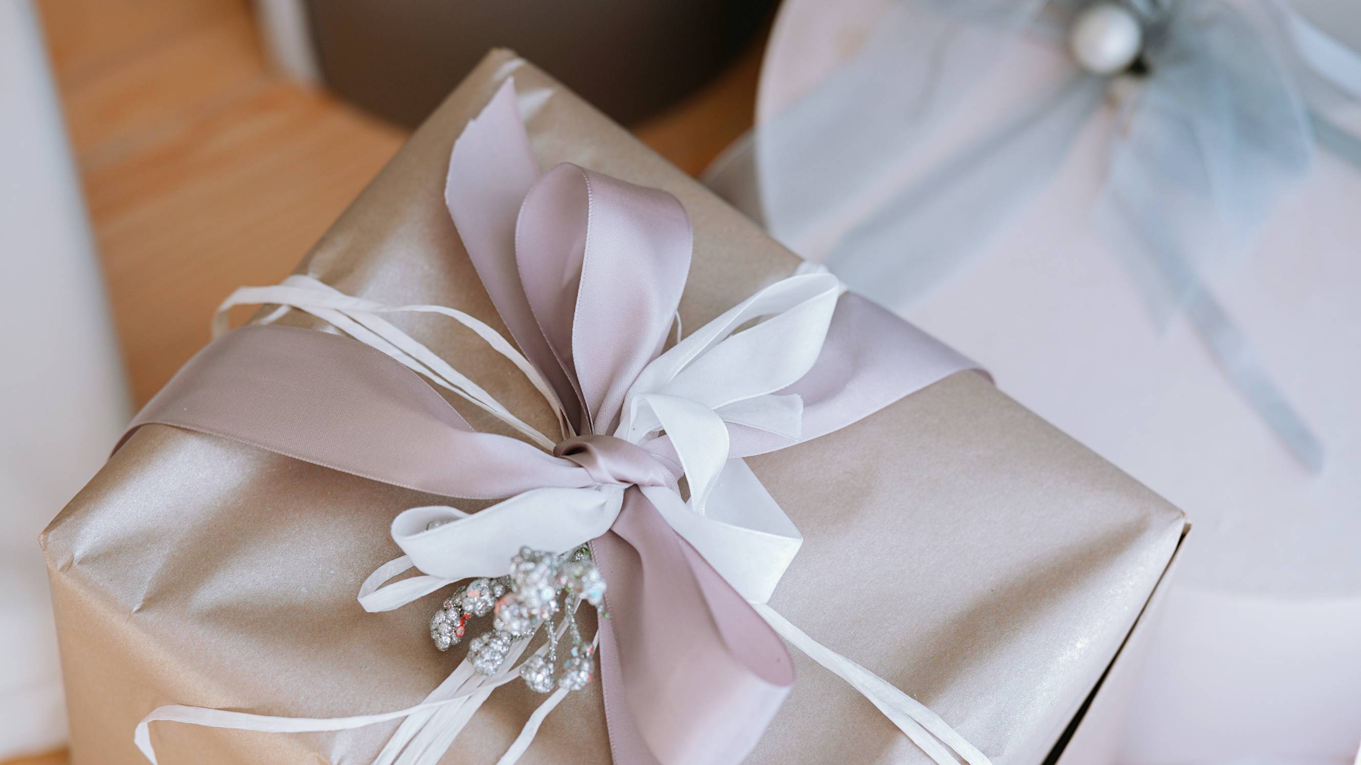 a wedding gift wrapped in blush pink paper