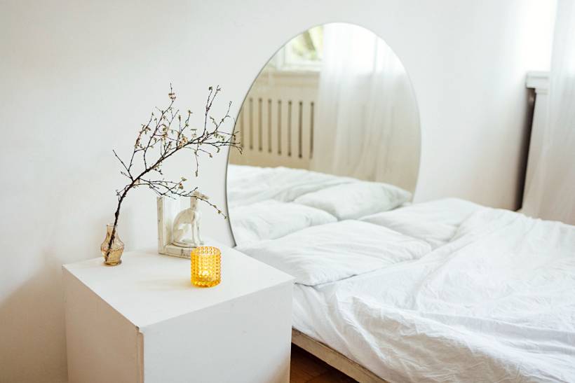 wedding gift ideas - Minimalist bedroom with arched mirror and white bedding