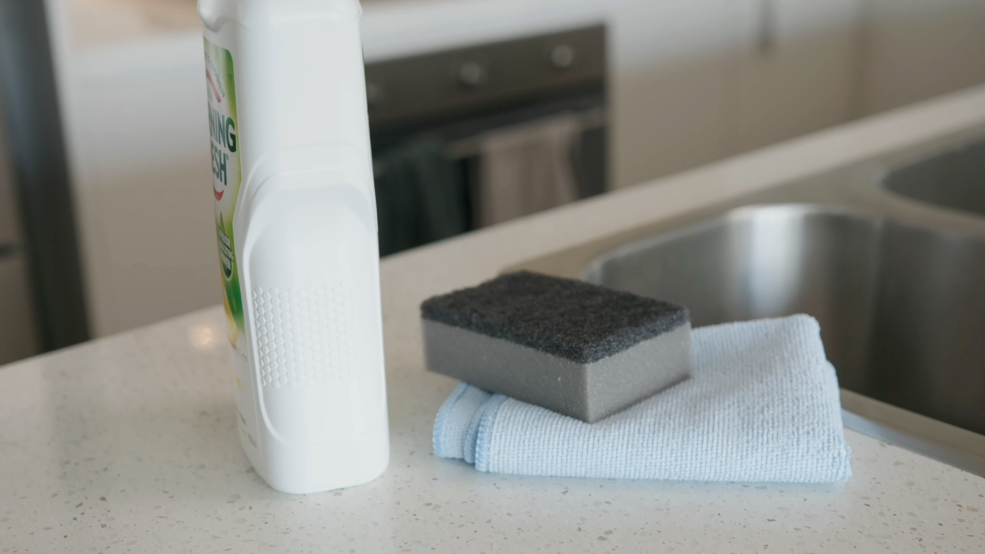 a bunch of cleaning supplies like sponge and microfibre towel for cleaning a rangehood