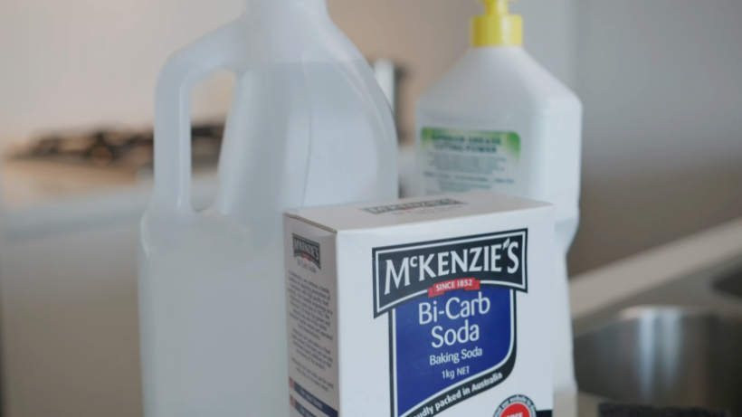bi-carb soda, vinegar, and other cleaning supplies to clean a dishwasher - cleaning a dishwasher