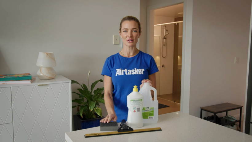 a cleaner showcasing the supplies needed to clean a showerglass - how to clean a showerglass