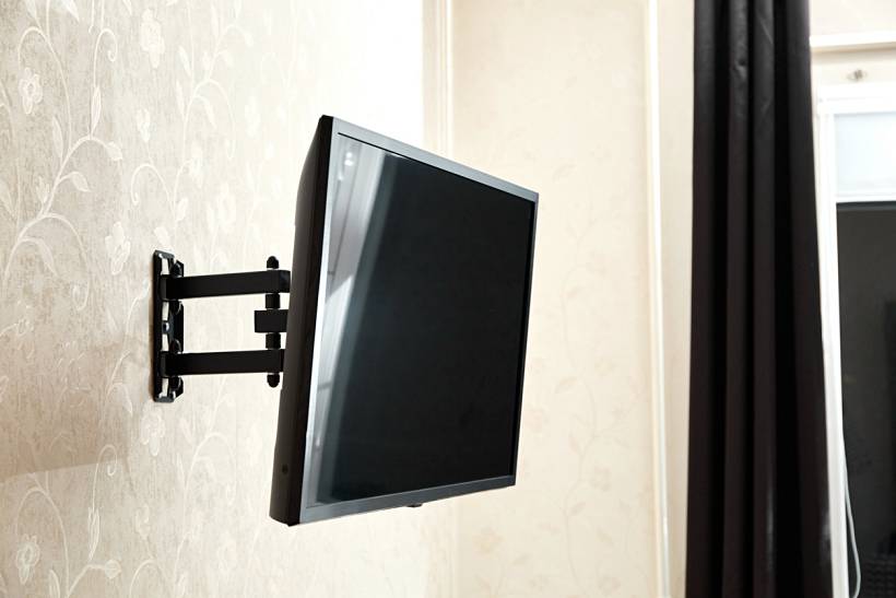 how much does it cost to wall mount a tv - Flat-screen TV mounted on an adjustable wall bracket