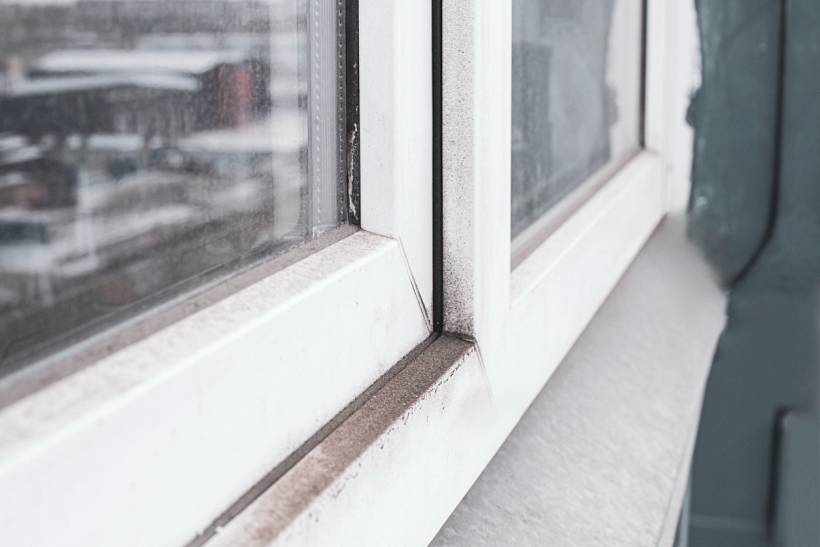 how much does window cleaning cost - Dirty window frame with visible dust and grime buildup
