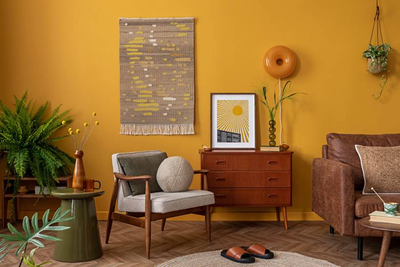 rug cleaning cost - Mustard yellow living room with round rug and vintage furniture