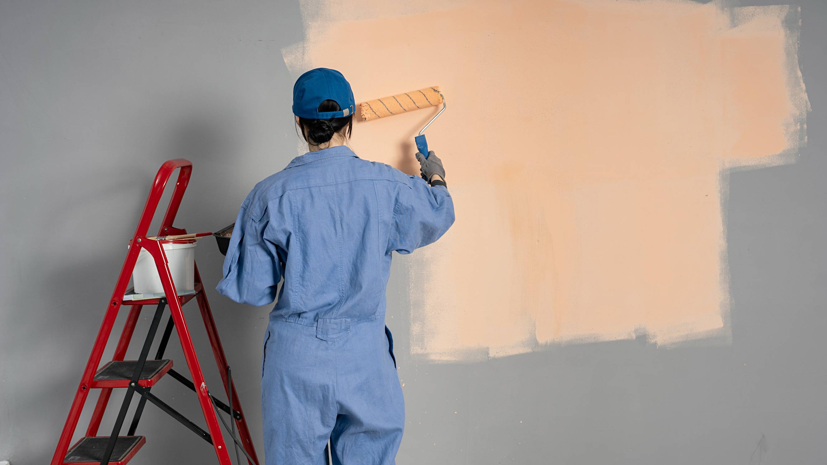 woman painting interior walls
