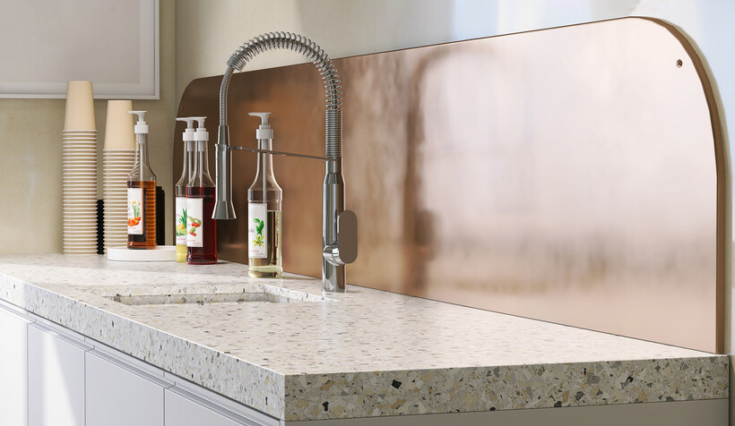 Warm copper-toned steel splashback panel with rounded edges paired with terrazzo benchtop. - kitchen splashback ideas
