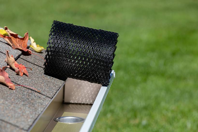 gutter guard installation cost - Black mesh gutter guard fitted along roof edge