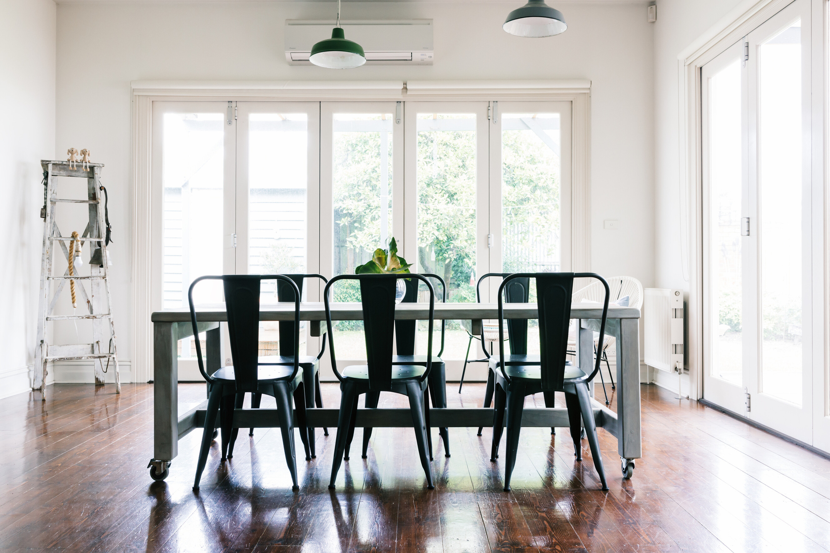 An open-plan dining room connects to the garden via bifold doors.