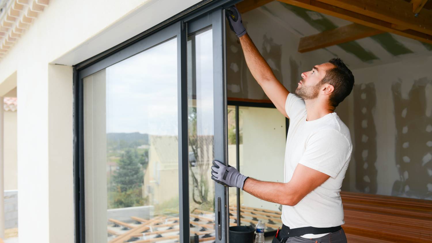 Tasker installing windows in a residential building