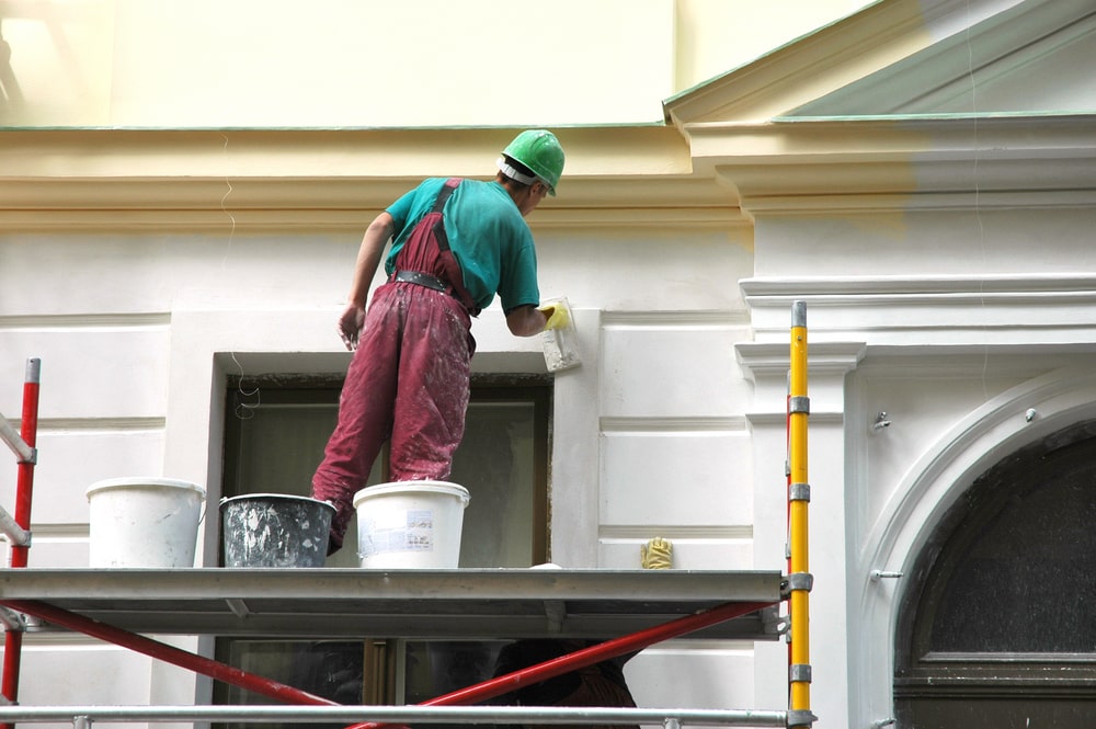 A painter painting exterior walls
