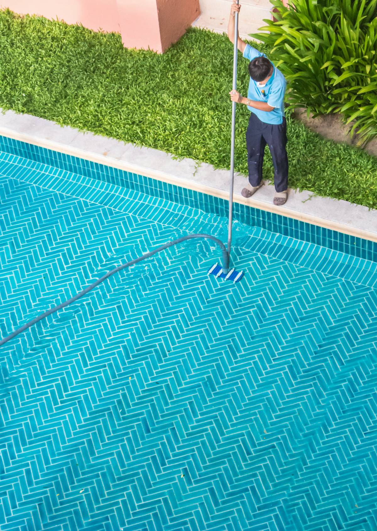 man cleaning a pool