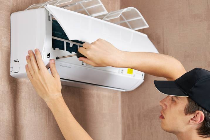 A man instaling an air conditioner