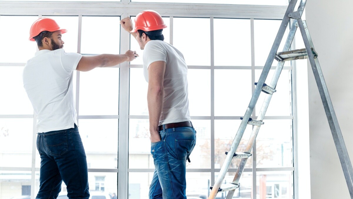 contractors discussing window measurement