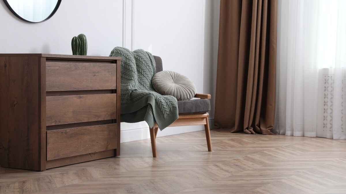 vinyl floor, chair with pillow, and cabinet with cactus furniture