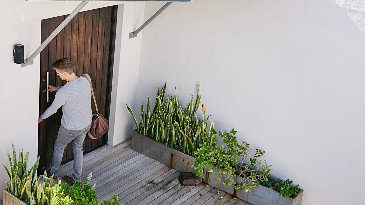 man opening front door