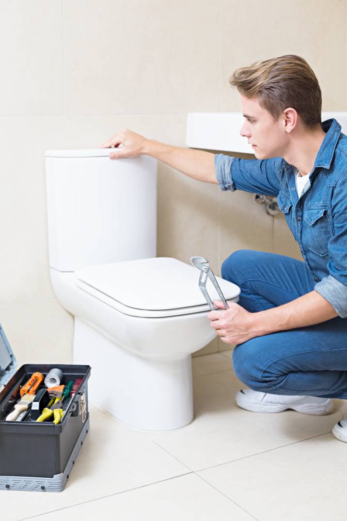 a handyman installing a toilet