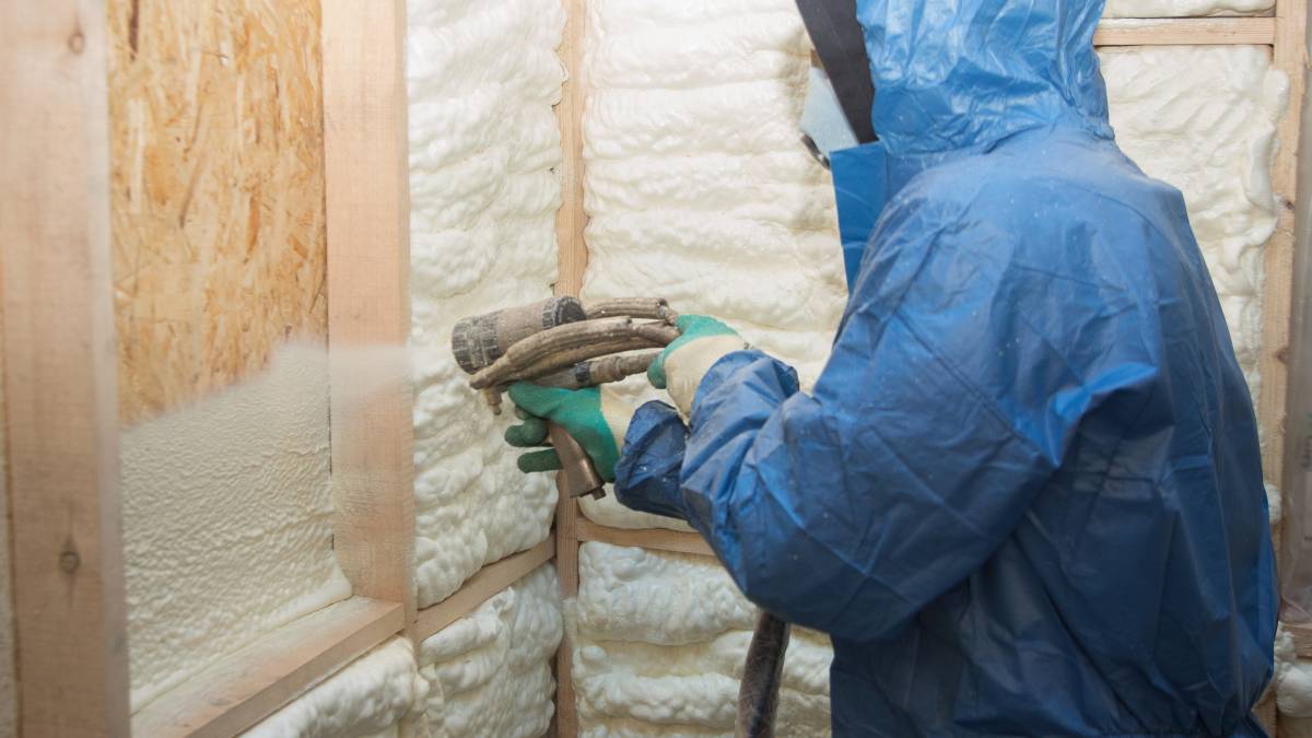 applying an insulating foam to a house wall