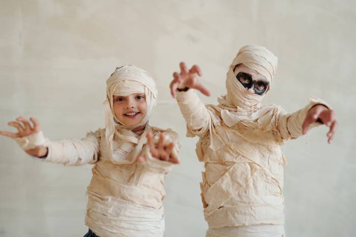 Kids wearing mummy costumes for Halloween