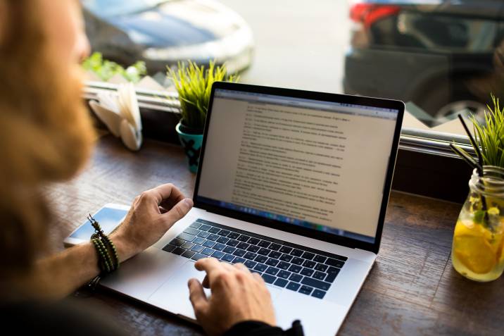 software engineer writing content for a blog while sitting in coffee shop