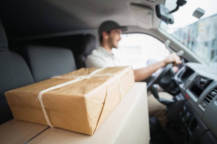 man driving van with parcels on seat, delivery driving to earn money with a car
