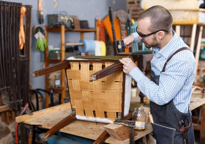 a man performing chair upholstery