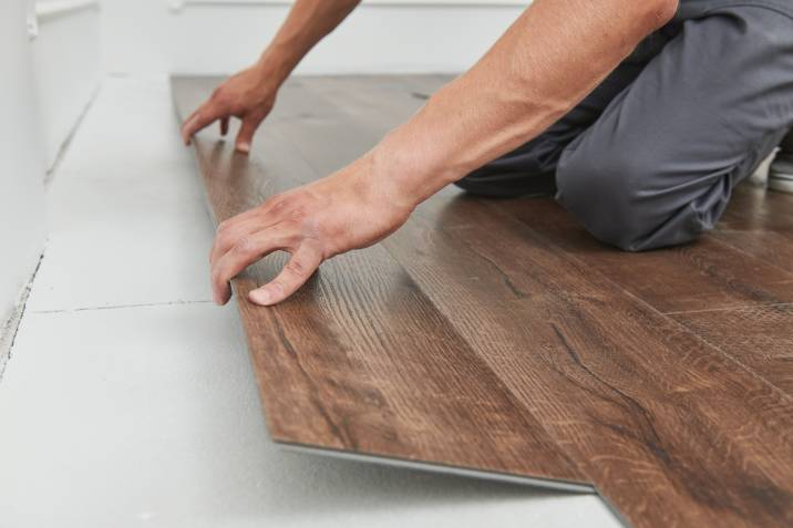 blue-collar worker joining vinyl floor covering
