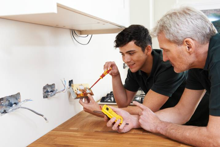 handyman with apprentice at a job site