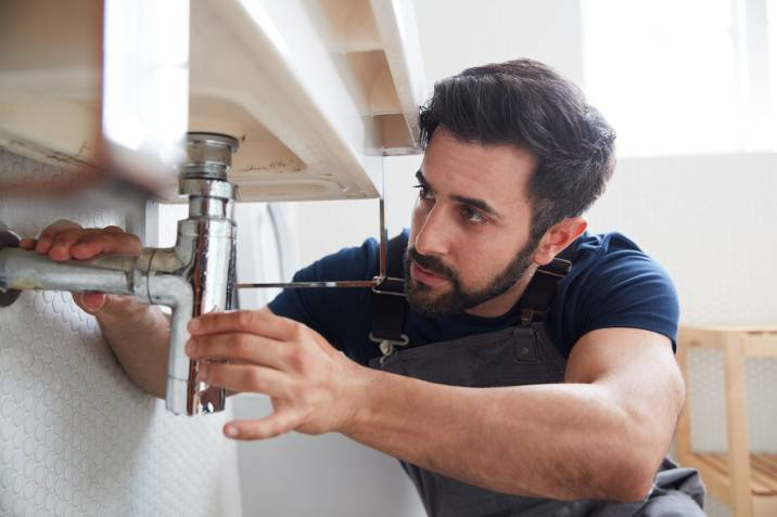handyman fixing sink
