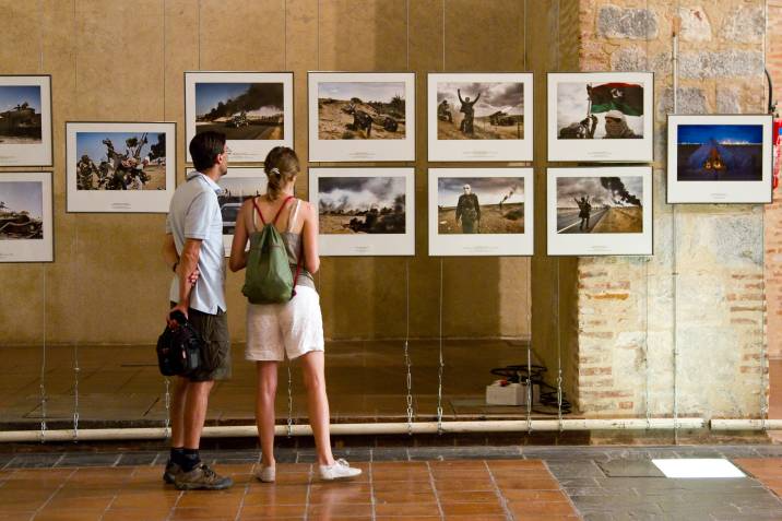 people looking through a photography exhibit