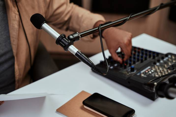 host working on a sound mixing desk in studio